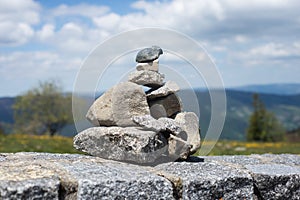 stone balance on stoned wall on mountain landscape background