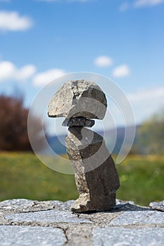Stone balance on stoned wall on mountain landscape background