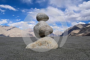 Stone balancing art at Nubra valley desert in Leh