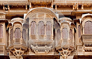 Stone balcony and carved windows of ancient stone fortress, Rajasthani, India