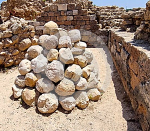 Stone balls for  catapult from the time of the Crusades in the fortress of the Crusaders in the Apollonia National Park in Israel