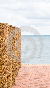 Stone barrier on beach with selective focus