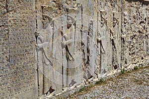 Stone bas-relief with warriors in ancient city Persepolis, Iran.