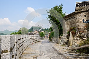 Stone battlements on side of way in ancient town on sunny spring