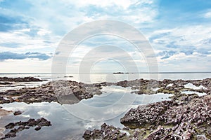 Stone on the beach and clound on the sky blue morning time