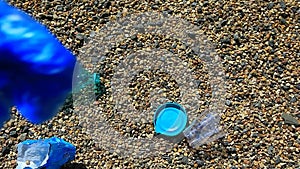 Stone beach plastic bottle package garbage hd footage