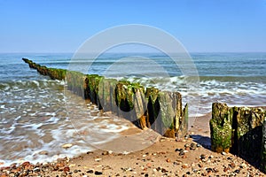 Stone beach and wooden breakwaters on the Baltic coast