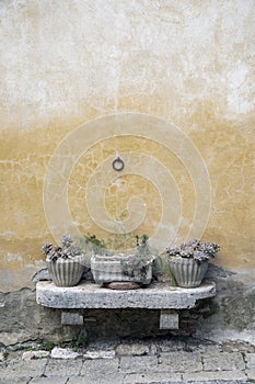 Stone bench in La Foce, Italy with pots for plants