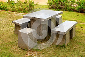 Stone benches table and stool at a garden in Phetchabun photo