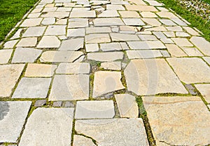 Stone blocks pavement in the city park.Pathway made with big asymmetrical stones