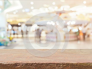 Stone board empty table in front of blurred background. Perspective brown stone over blur in coffee shop - can be used for