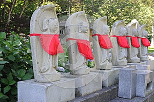 Stone bodhisattvas with red aprons in Japan photo