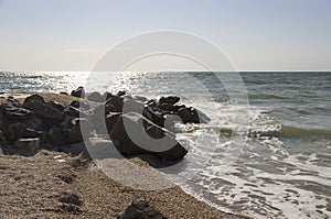 Stone boulders on the sandy spit