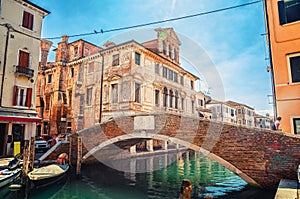 Stone brick bridge Ponte Caneva across Vena water canal in historical centre of Chioggia