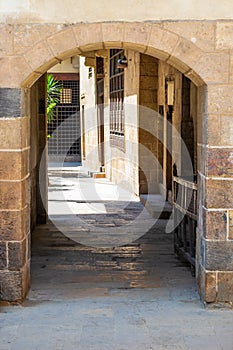 Stone bricks wall with aged vaulted passage, Old Cairo, Egypt photo