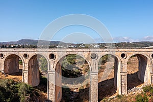 The stone bridge of Katouni in Kythira Greece with arches and round openings, sunny day