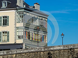 Stone bridge with lampposts and typical house with gallery of colors in Pau, France