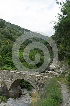 Stone bridge in mountains in the Nervia Valley photo