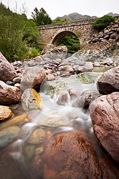 Stone bridge over Fango river, Corsica, France photo