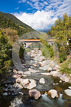 Stone bridge over river Isarco, Chiusa, Italy photo
