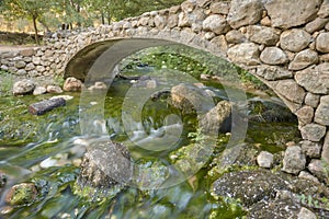 Stone bridge over the source of the Cerzo river in Villanueva del Rosario, MÃÂ¡laga. Spain photo