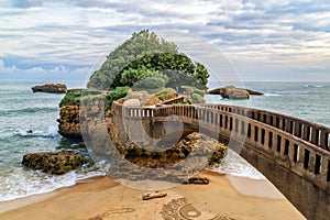 Stone bridge to the Rocher du Basta, the landmark of the coast of Biarritz, France. photo