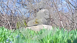 Stone Buddha sculpture in the garden in slow motion