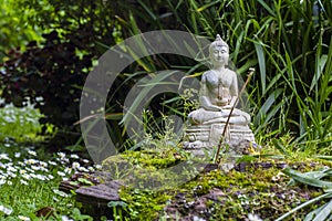 Stone buddha in a zen garden