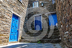 Stone building with blue doors under sunlight in Piodao village in Portugal