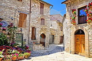 Stone buildings of the flower filled old town of Assisi, Italy