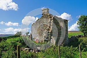 Stone built farmhouse ruin.