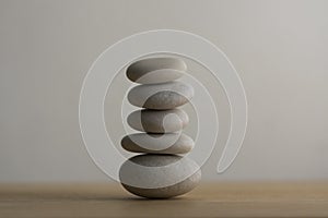 Stone cairn on white background, five stones tower, simple poise stones, simplicity harmony and balance, rock zen