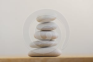 Stone cairn on white background, five stones tower, simple poise stones, simplicity harmony and balance, rock zen