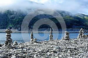 Stone cairns on the coast of river, Norway