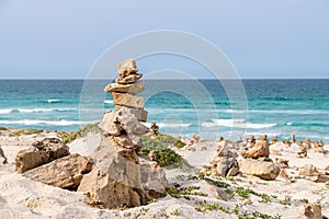 Stone cairns on tropical beach Boa Vista Cape Verde