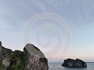 A stone in a calm sea at sunset