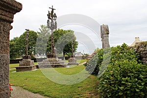 stone calvary in front of the sainte-marie-du-mÃ©nez-hom chapel in plomodiern in brittany (france) photo