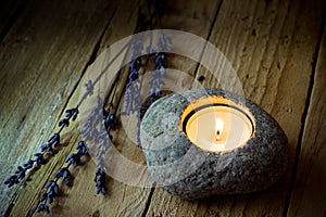 Stone candle holder with tea light on barn wood, lavender twigs, Easter, tranquility