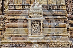 Stone carved erotic bas relief in Hindu temple in Khajuraho, India.