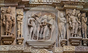 Stone carved erotic bas relief in Hindu temple in Khajuraho, India.