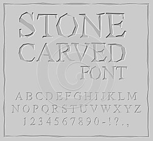 Stone Carved font. Alphabet on rock plate. Chips and scratches.