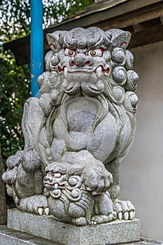 Stone carved Komainu Lion-dog guardian at Suzukamyo Shrine photo