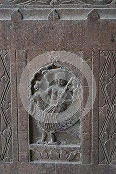 Stone carving art with Hindu deity   figure on the pillar of ancient architecture of India