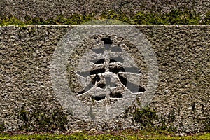 Stone carving of Japanese kanji character. TRANSLATION: observance, offer, present, dedicate