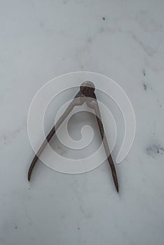 Stone carving tools on a white marble sculpture.