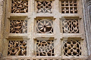 Stone carvings on outer wall of Jami Masjid , UNESCO protected Champaner - Pavagadh Archaeological Park, Gujarat, India