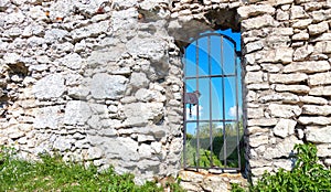 Stone castle wall with a metal passage to the courtyard