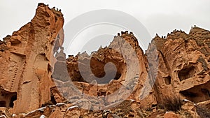 Stone cave houses and ancient monasteries with volcanic rock landscape at Zelve Valley in Cappadocia, Turkey