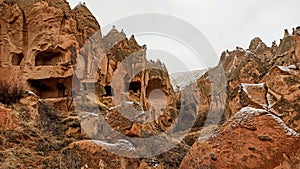 Stone cave houses and ancient monasteries with volcanic rock landscape at Zelve Valley in Cappadocia, Turkey