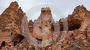 Stone cave houses and ancient monasteries with volcanic rock landscape at Zelve Valley in Cappadocia, Turkey